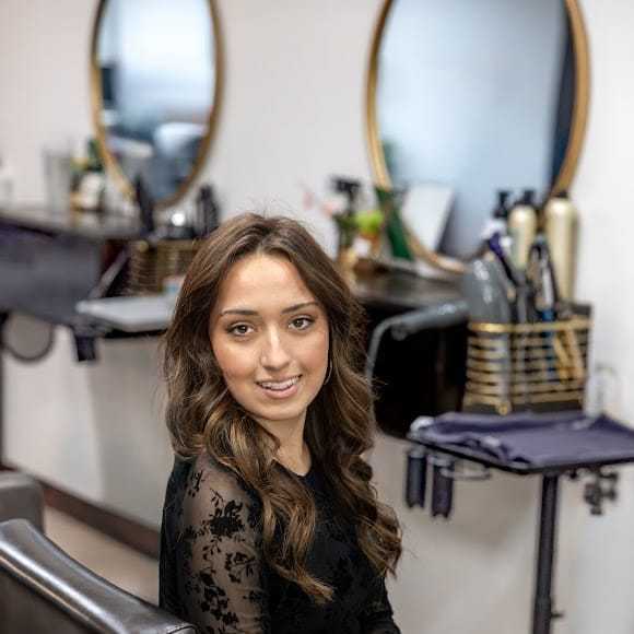 Portrait of Michaela Thompson, a professional stylist at Revive Hair Salon & Day Spa, showcasing their expertise and style.