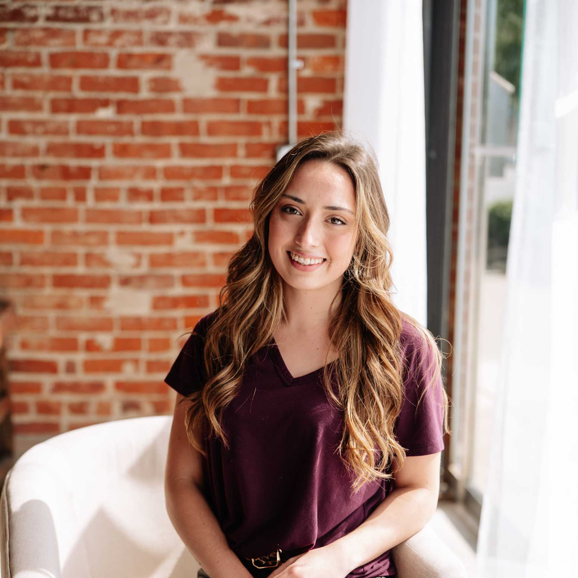 Portrait of Michaela Thompson, a professional stylist at Revive Hair Salon & Day Spa, showcasing their expertise and style.