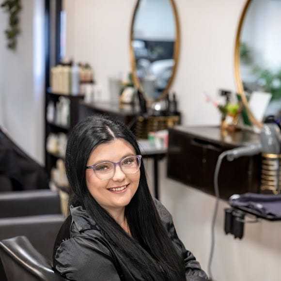 Portrait of Ashley Maag, a professional stylist at Revive Hair Salon & Day Spa, showcasing their expertise and style.