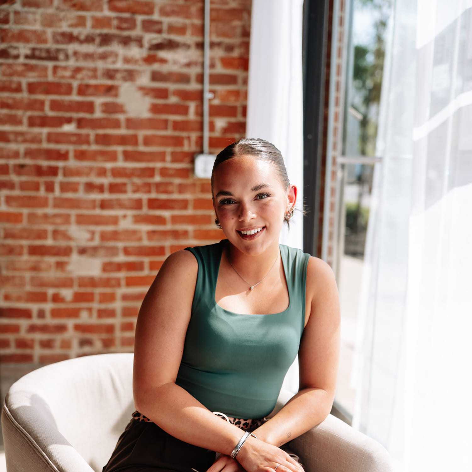 Portrait of Sara Lynch, a professional stylist at Revive Hair Salon & Day Spa, showcasing their expertise and style.