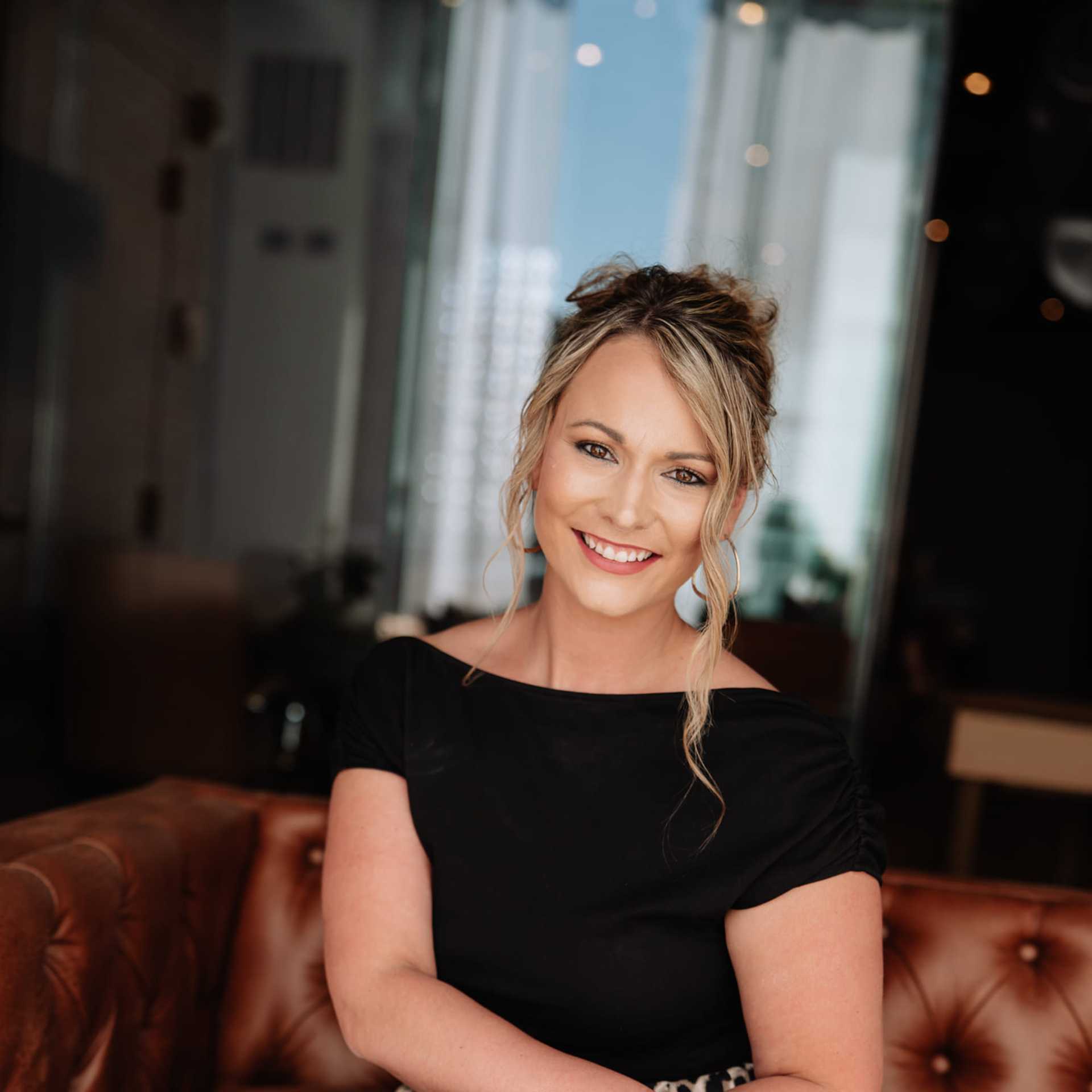 Portrait of Ashley Boehler, a professional stylist at Revive Hair Salon & Day Spa, showcasing their expertise and style.