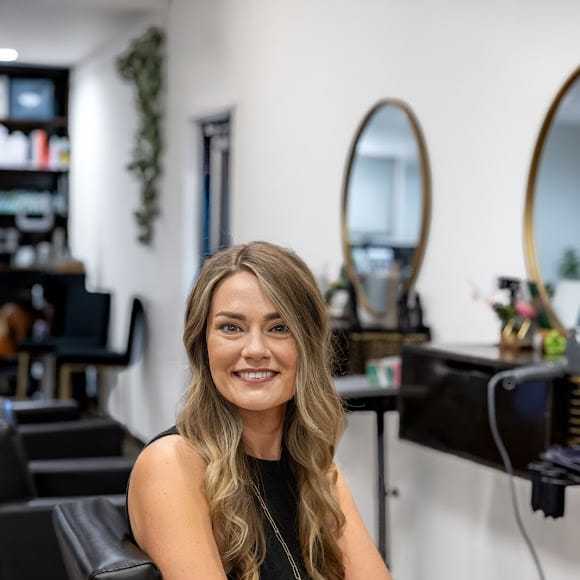 Portrait of Weslie Cheney, a professional stylist at Revive Hair Salon & Day Spa, showcasing their expertise and style.
