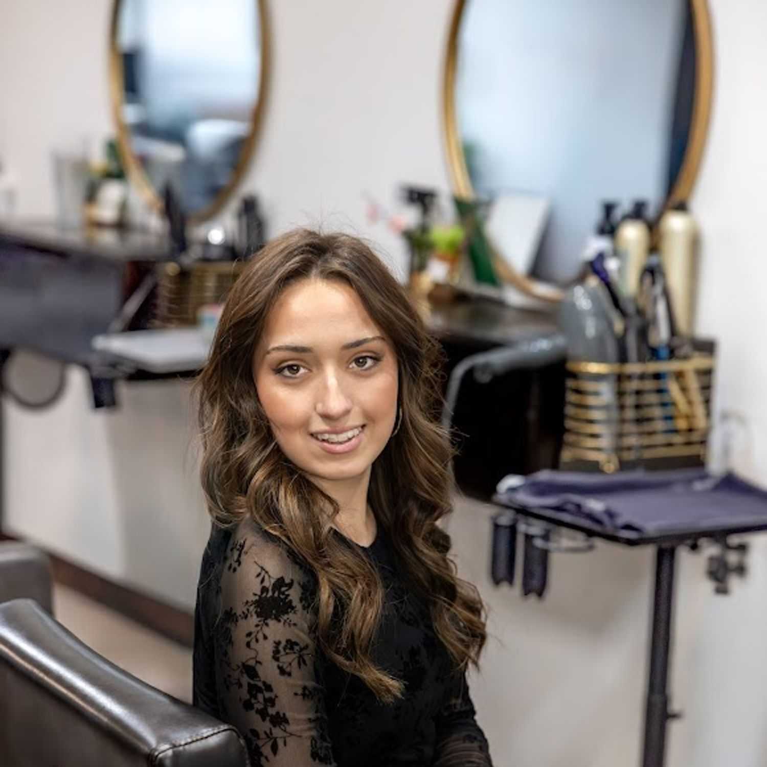Portrait of Michaela Thompson, a professional stylist at Revive Hair Salon & Day Spa, showcasing their expertise and style.