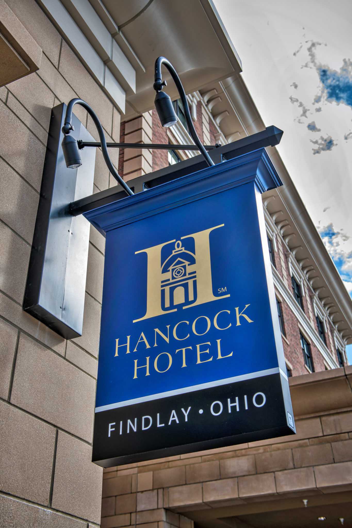 Sign for Hancock Hotel in Findlay, Ohio, mounted on a brick building.